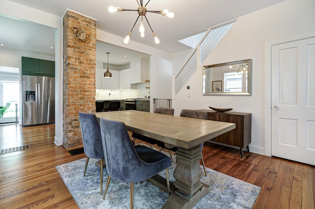 432 E Kossuth St, Columbus, OH 43206 - dining area with healthy amount of natural light, hardwood / wood-style flooring, and a chandelier