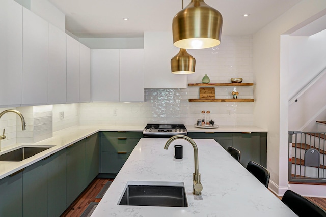 432 E Kossuth St, Columbus, OH 43206 - kitchen featuring a sink, stainless steel range, tasteful backsplash, light stone countertops, and recessed lighting