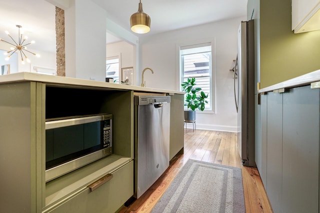432 E Kossuth St, Columbus, OH 43206 - kitchen with stainless steel appliances, light wood-type flooring, plenty of natural light, and a chandelier