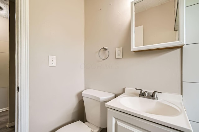 4736 Arnold Ave, Columbus, OH 43228 - bathroom with toilet, vanity, and a textured ceiling