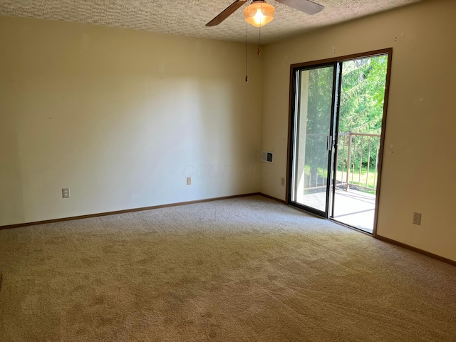 3965 Karl Rd Unit 200, Columbus, OH 43224 - empty room featuring a textured ceiling, carpet floors, ceiling fan, and baseboards