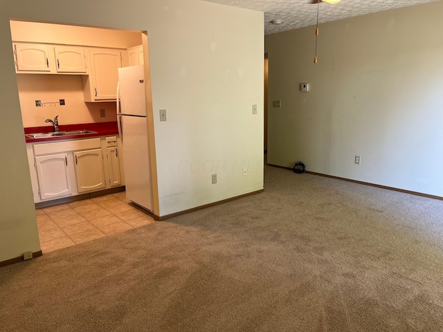 3965 Karl Rd Unit 200, Columbus, OH 43224 - empty room with a sink, light colored carpet, baseboards, and a textured ceiling