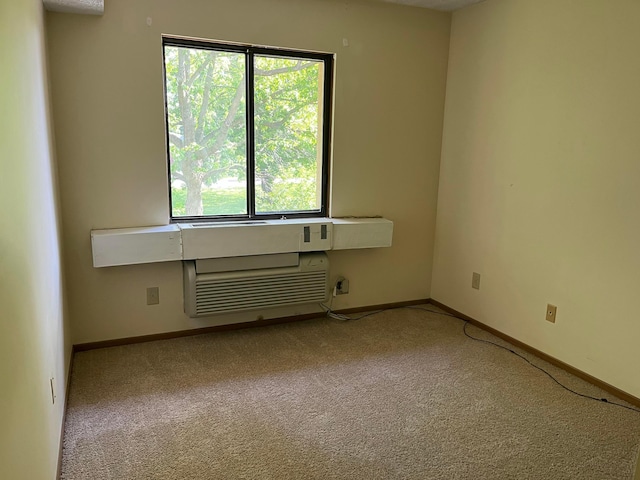 3965 Karl Rd Unit 200, Columbus, OH 43224 - unfurnished room with carpet, baseboards, and a wall mounted air conditioner