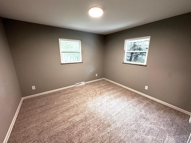 239 Maplewood Ave, Columbus, OH 43213 - carpeted empty room with healthy amount of natural light and baseboards
