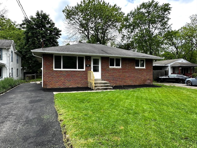 239 Maplewood Ave, Columbus, OH 43213 - view of front of house with brick siding, roof with shingles, and driveway