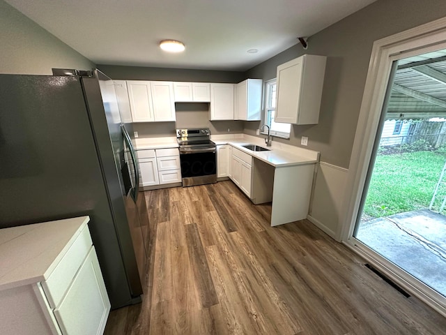 239 Maplewood Ave, Columbus, OH 43213 - kitchen featuring stainless steel appliances, a sink, dark wood-style floors, and healthy amount of natural light
