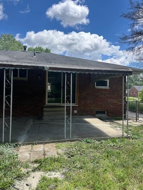 239 Maplewood Ave, Columbus, OH 43213 - rear view of property with brick siding and a patio area