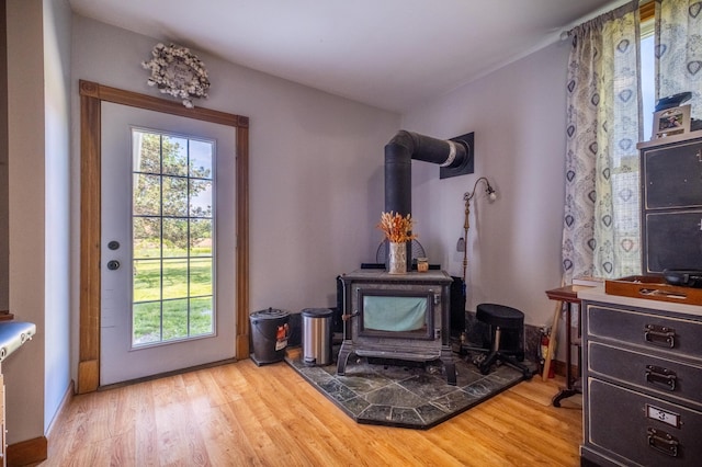 4842 State Route 734, Jeffersonville, OH 43128 - living area featuring a wood stove, healthy amount of natural light, and light wood-type flooring