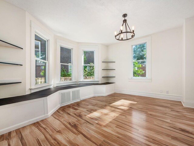 534 Berkeley Rd, Columbus, OH 43205 - unfurnished dining area with a chandelier, plenty of natural light, and light wood-style flooring