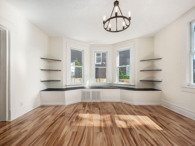 534 Berkeley Rd, Columbus, OH 43205 - unfurnished dining area with wood finished floors, a chandelier, and healthy amount of natural light