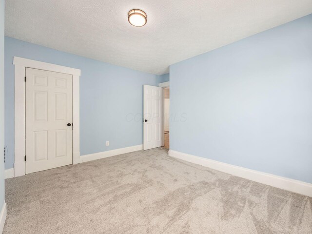 534 Berkeley Rd, Columbus, OH 43205 - spare room featuring light colored carpet, baseboards, and a textured ceiling