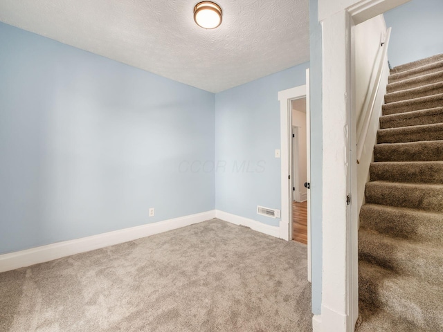 534 Berkeley Rd, Columbus, OH 43205 - stairway with carpet floors, baseboards, and a textured ceiling