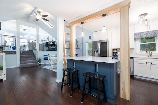 11177 Sassafrass Rd, Lakeview, OH 43331 - kitchen featuring appliances with stainless steel finishes, a sink, ceiling fan, white cabinets, and a breakfast bar