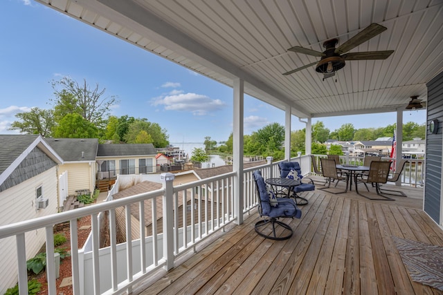 11177 Sassafrass Rd, Lakeview, OH 43331 - wooden terrace featuring outdoor dining space, a ceiling fan, and a water view