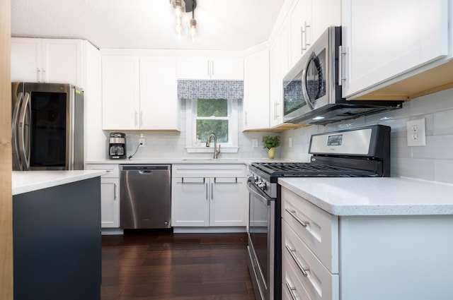 11177 Sassafrass Rd, Lakeview, OH 43331 - kitchen featuring appliances with stainless steel finishes, a sink, decorative backsplash, and white cabinets