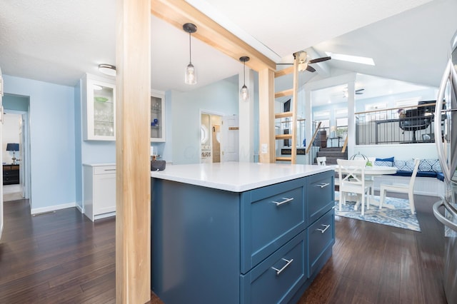 11177 Sassafrass Rd, Lakeview, OH 43331 - kitchen with dark wood-style floors, a ceiling fan, light countertops, decorative light fixtures, and blue cabinetry