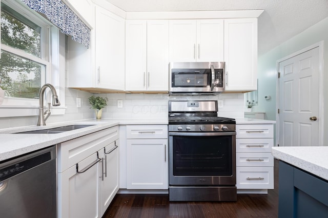 11177 Sassafrass Rd, Lakeview, OH 43331 - kitchen featuring stainless steel appliances, a sink, tasteful backsplash, dark wood-style flooring, and white cabinets