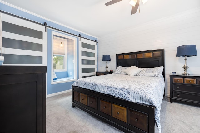 11177 Sassafrass Rd, Lakeview, OH 43331 - bedroom with a barn door, light carpet, crown molding, wooden walls, and a ceiling fan