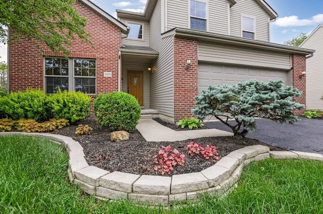 5409 Wellcrest Ct, Galloway, OH 43119 - view of exterior entry with brick siding and an attached garage