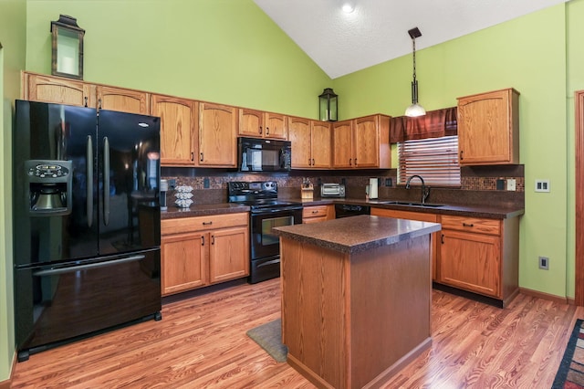 5409 Wellcrest Ct, Galloway, OH 43119 - kitchen with black appliances, a sink, high vaulted ceiling, tasteful backsplash, and dark countertops
