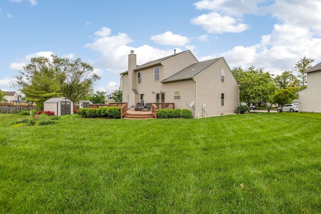 5409 Wellcrest Ct, Galloway, OH 43119 - back of property featuring a deck, a chimney, and a lawn