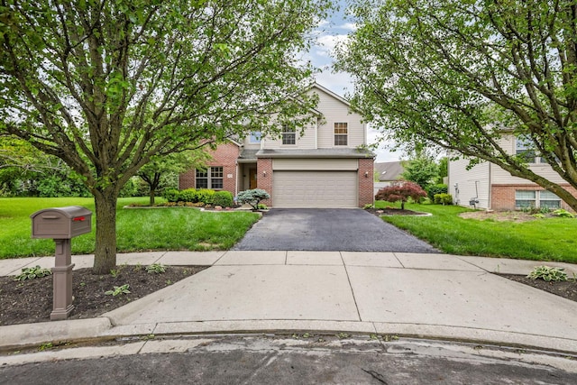 5409 Wellcrest Ct, Galloway, OH 43119 - view of front of home with brick siding, driveway, a front yard, and a garage