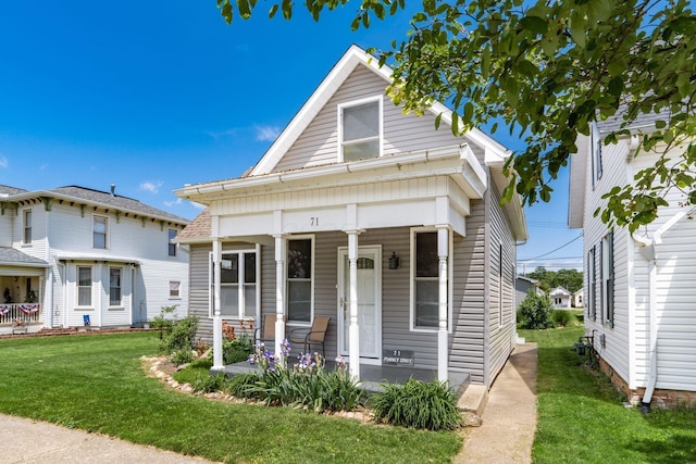 71 Market St, Carroll, OH 43112 - view of front of house with a front lawn and a porch