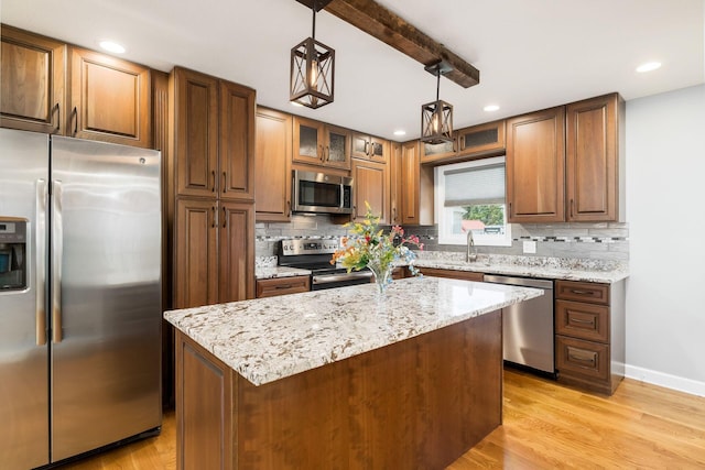 71 Market St, Carroll, OH 43112 - kitchen with stainless steel appliances, tasteful backsplash, light stone countertops, pendant lighting, and recessed lighting