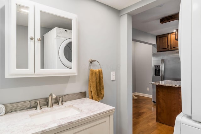 71 Market St, Carroll, OH 43112 - bathroom featuring wood finished floors, vanity, and stacked washer / drying machine