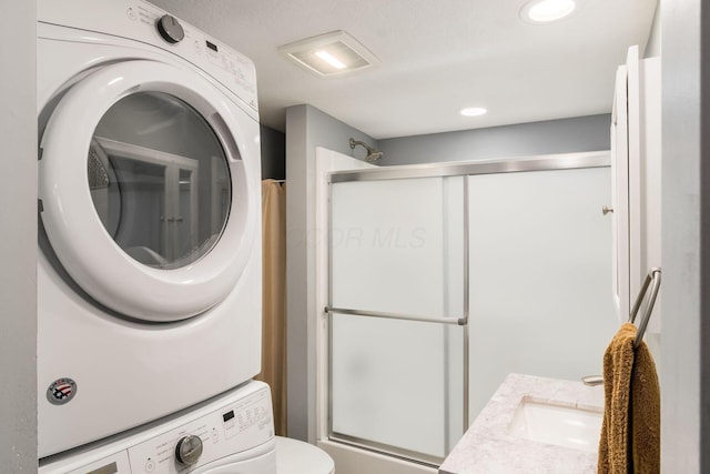71 Market St, Carroll, OH 43112 - bathroom with stacked washer / drying machine, an enclosed shower, vanity, and toilet
