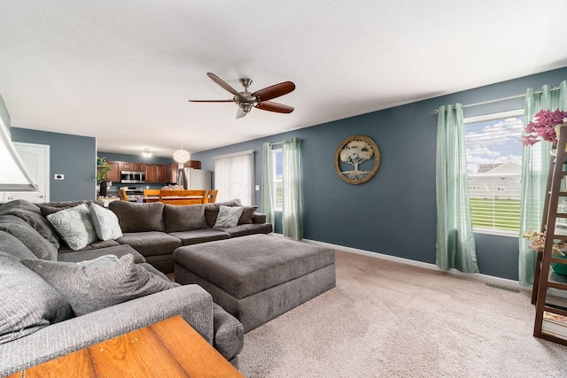 21 Mandolin Ct, Etna, OH 43062 - living room with healthy amount of natural light, a ceiling fan, light carpet, and baseboards