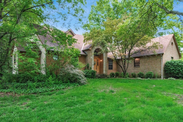 248 Academy Woods Dr, Columbus, OH 43230 - view of front of house featuring brick siding, a front lawn, and a shingled roof