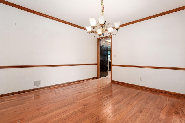 248 Academy Woods Dr, Columbus, OH 43230 - unfurnished room with a chandelier, light wood-type flooring, baseboards, and ornamental molding
