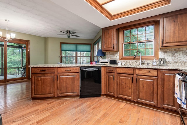 248 Academy Woods Dr, Columbus, OH 43230 - kitchen featuring black dishwasher, brown cabinetry, light wood-type flooring, and backsplash