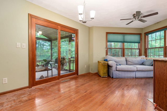 248 Academy Woods Dr, Columbus, OH 43230 - living area with light wood-style flooring, a chandelier, a ceiling fan, and baseboards