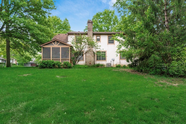 248 Academy Woods Dr, Columbus, OH 43230 - back of property with a sunroom, a chimney, stucco siding, a yard, and central air condition unit