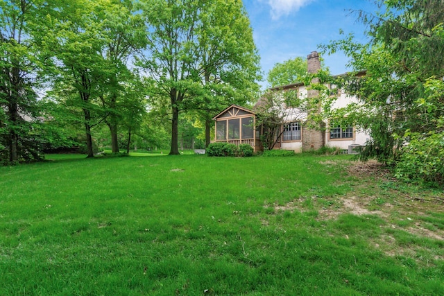 248 Academy Woods Dr, Columbus, OH 43230 - view of grassy yard featuring a sunroom