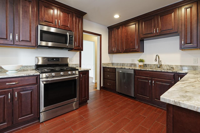 68 N Broadleigh Rd, Columbus, OH 43209 - kitchen featuring appliances with stainless steel finishes, dark wood-type flooring, light stone countertops, recessed lighting, and dark brown cabinets