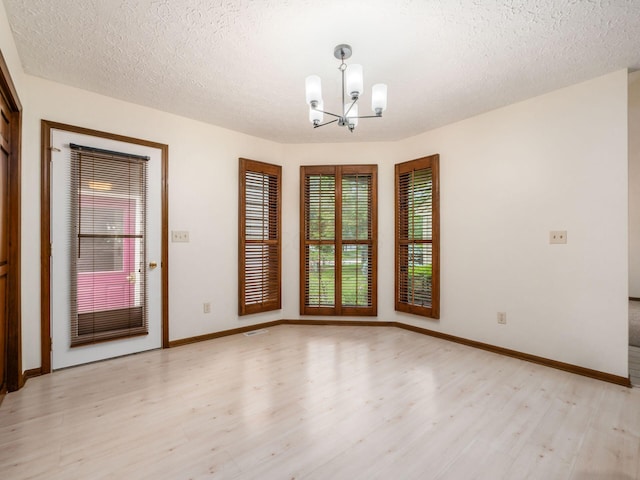 1288 Millstone Sq, Westerville, OH 43081 - empty room featuring light wood finished floors, a chandelier, baseboards, and a textured ceiling