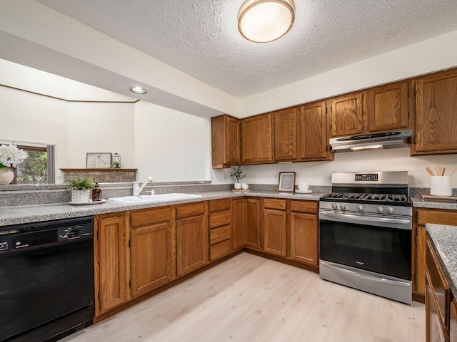 1288 Millstone Sq, Westerville, OH 43081 - kitchen with stainless steel range with gas stovetop, black dishwasher, under cabinet range hood, a sink, and light wood-type flooring
