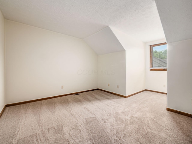 1288 Millstone Sq, Westerville, OH 43081 - bonus room featuring carpet, vaulted ceiling, baseboards, and a textured ceiling