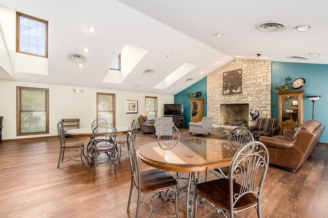 1288 Millstone Sq, Westerville, OH 43081 - dining area featuring a skylight, vaulted ceiling, wood finished floors, a stone fireplace, and baseboards