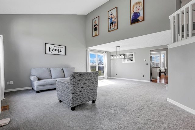 9556 Ireland Ct, Powell, OH 43065 - carpeted living room with a high ceiling, plenty of natural light, and baseboards