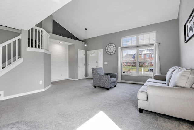 9556 Ireland Ct, Powell, OH 43065 - living room with carpet floors, baseboards, stairway, and high vaulted ceiling