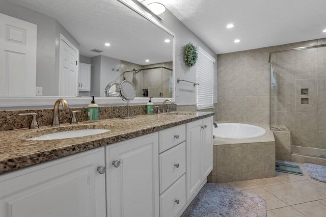 9556 Ireland Ct, Powell, OH 43065 - bathroom featuring tile patterned floors, a stall shower, recessed lighting, double vanity, and a garden tub