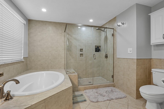 9556 Ireland Ct, Powell, OH 43065 - bathroom featuring a stall shower, toilet, a garden tub, tile walls, and tile patterned floors