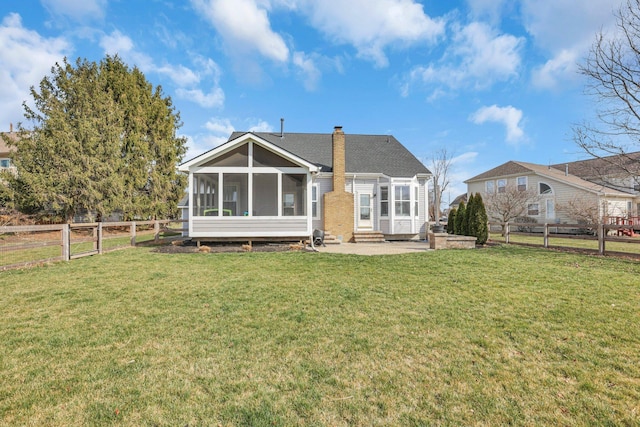 9556 Ireland Ct, Powell, OH 43065 - rear view of property featuring a sunroom, a patio area, a chimney, and entry steps