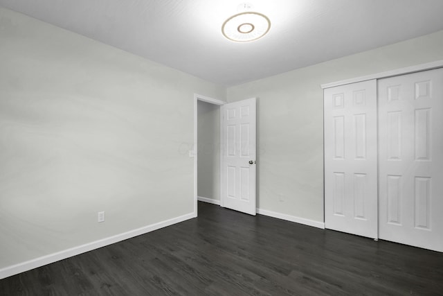 2751 Baker Ave, Cincinnati, OH 45211 - unfurnished bedroom with dark wood-style floors, baseboards, and a closet