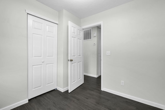 2751 Baker Ave, Cincinnati, OH 45211 - unfurnished bedroom featuring dark wood-style flooring, baseboards, and a closet