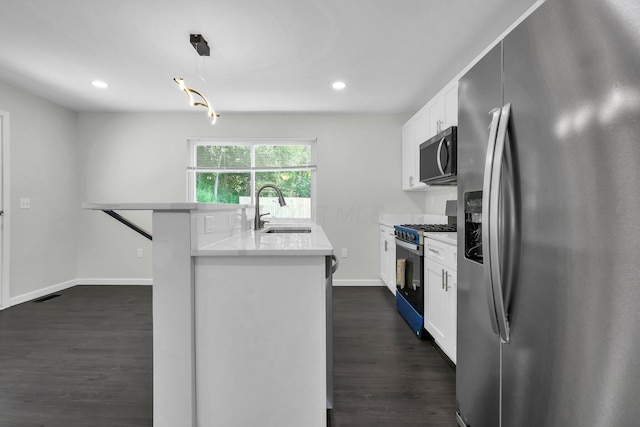 2751 Baker Ave, Cincinnati, OH 45211 - kitchen featuring stainless steel appliances, a sink, white cabinetry, light countertops, and dark wood-style flooring
